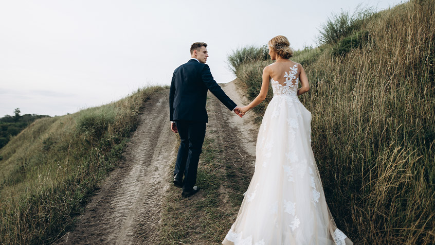 married couple walking on a trail