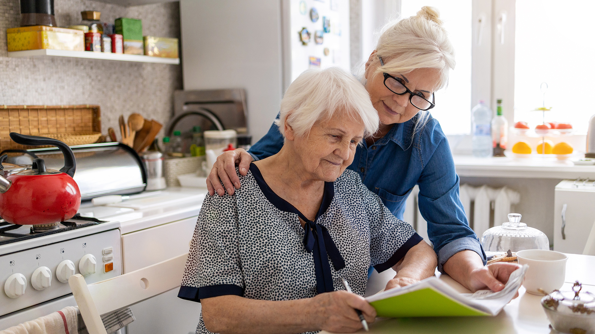 two women looking at a paper