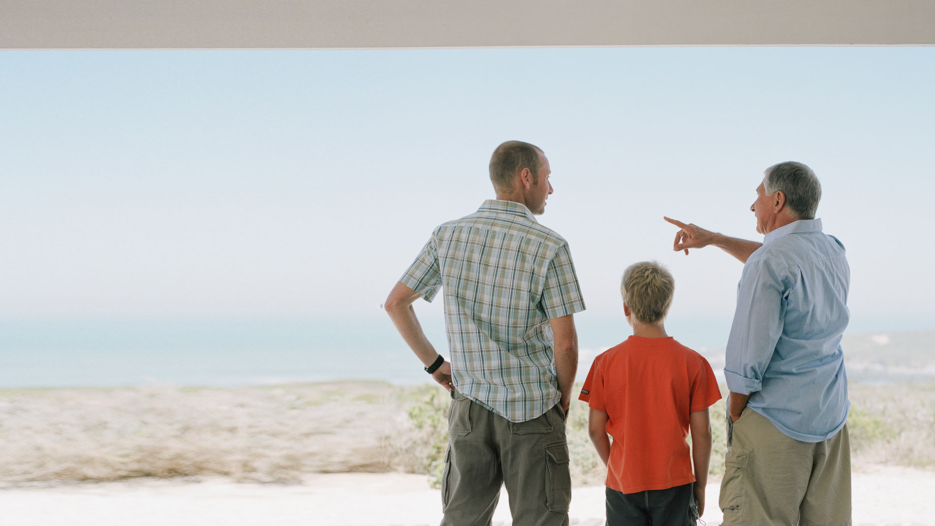 Three generations - grandfather, father, son - standing together
