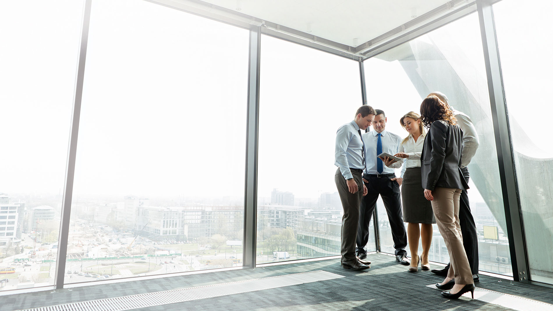 Group of employees looking at the plans in their new office space.