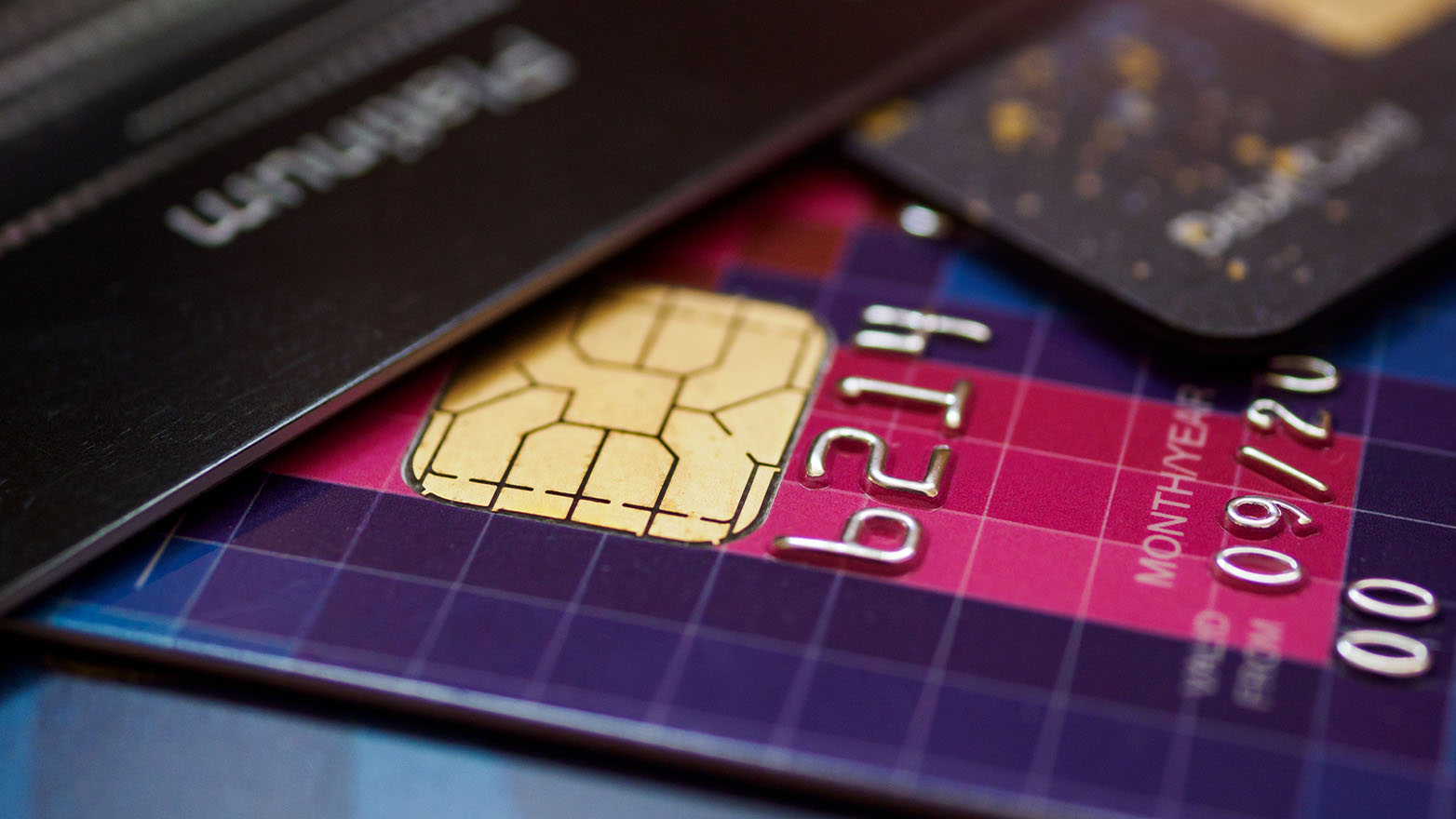 A close-up of a credit card showing a gold chip, partial account number 6214, and an expiration date of September 2020.