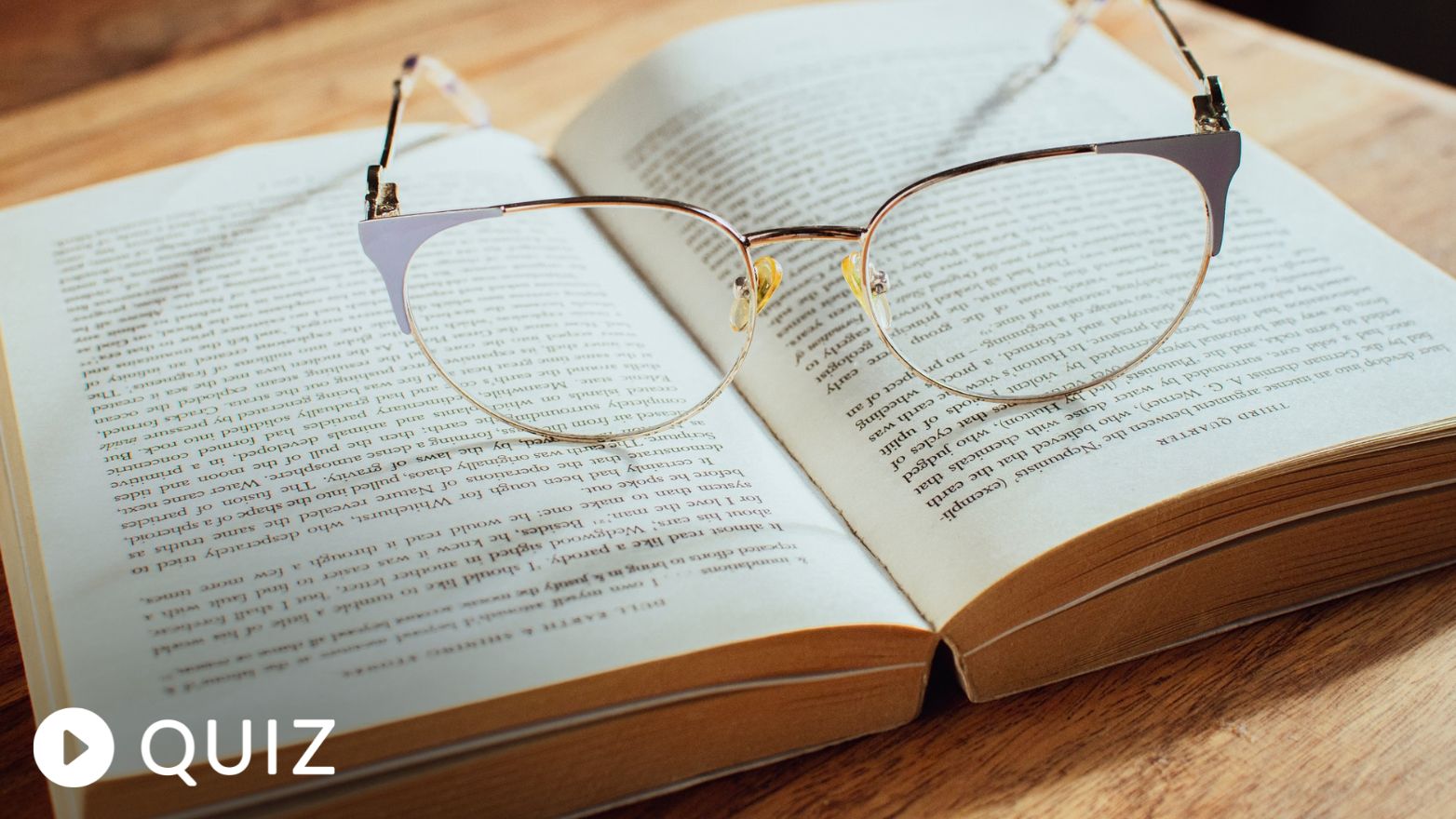 glasses resting on the center of an open book