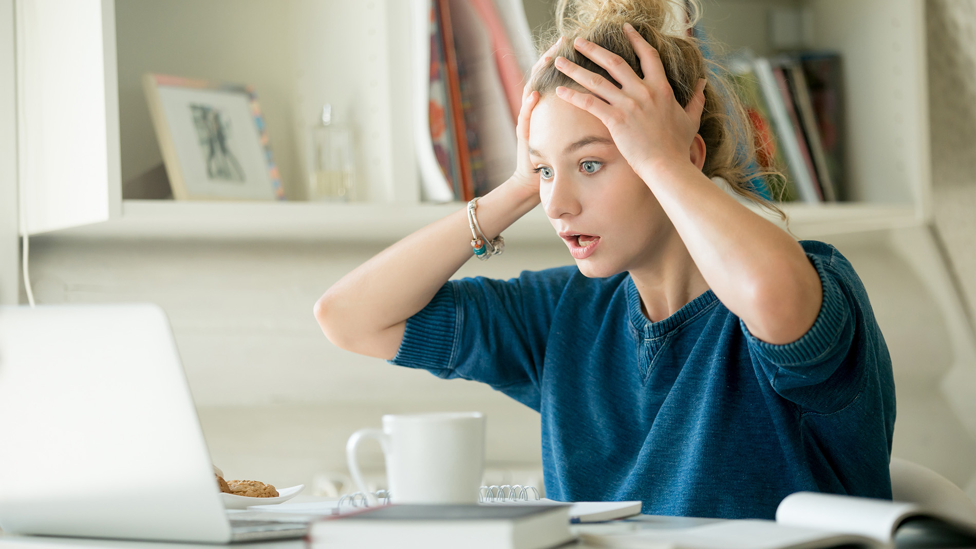 woman shocked looking at her laptop