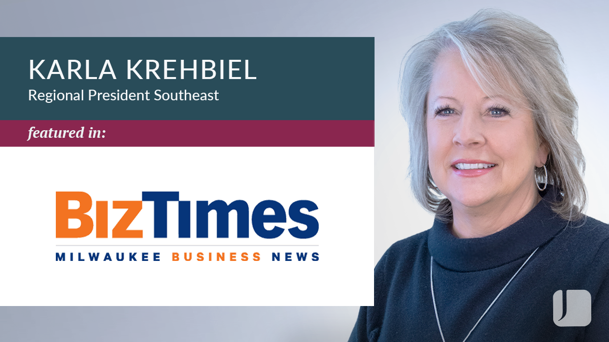 Karla Krehbiel next to Biz Times Logo