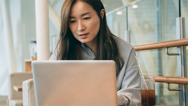 Woman looking at laptop.