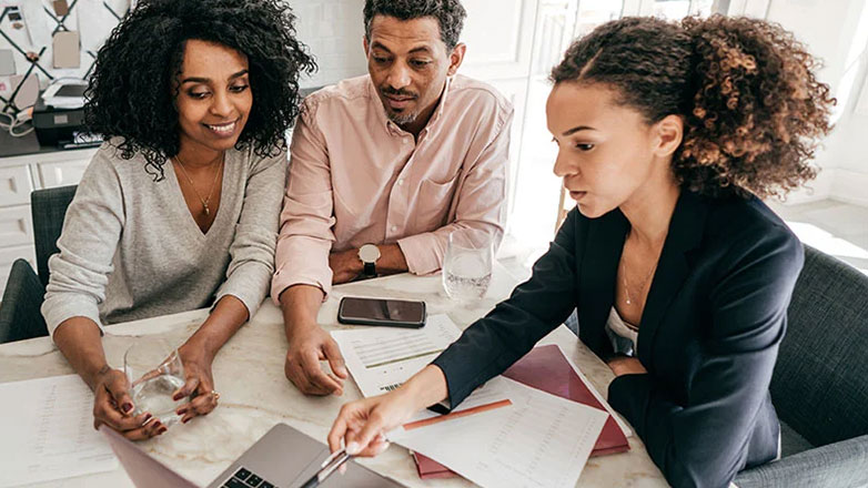 Financial advisor meets with mature couple to discuss their retirement plans.