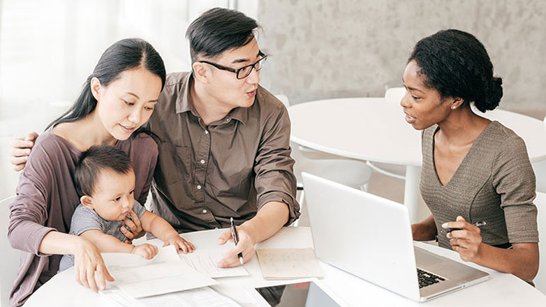 Financial advisor meets with a young family to discuss their portfolio.