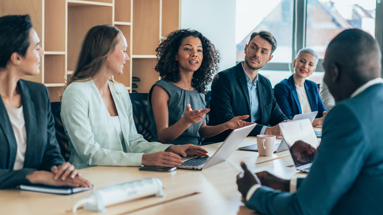 Colleagues gathered at a meeting in their conference room.