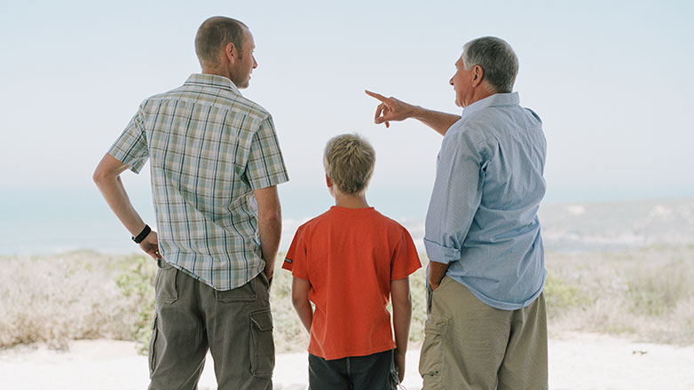 Three generations - grandfather, father, son - standing together