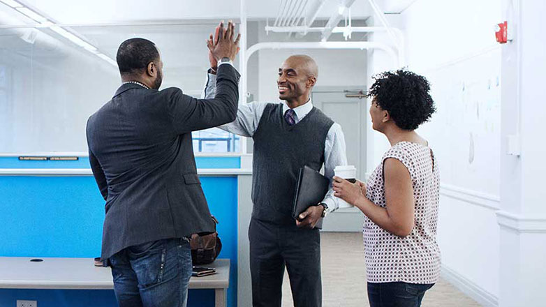 Group of colleagues celebrate their new office space.