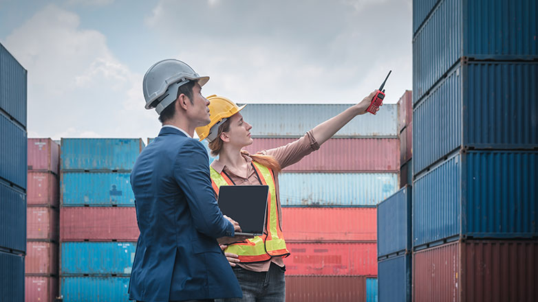 Employee gives business owner a tour of the shipping yard.