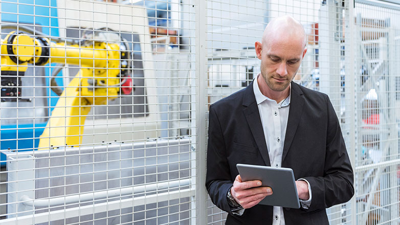 Man standing in a manufacturing facility.