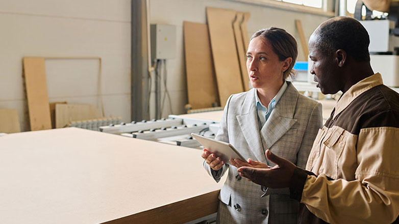 Manager tours the warehouse with the facilities supervisor.