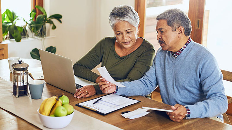 An older couple reviews their financial documents together.