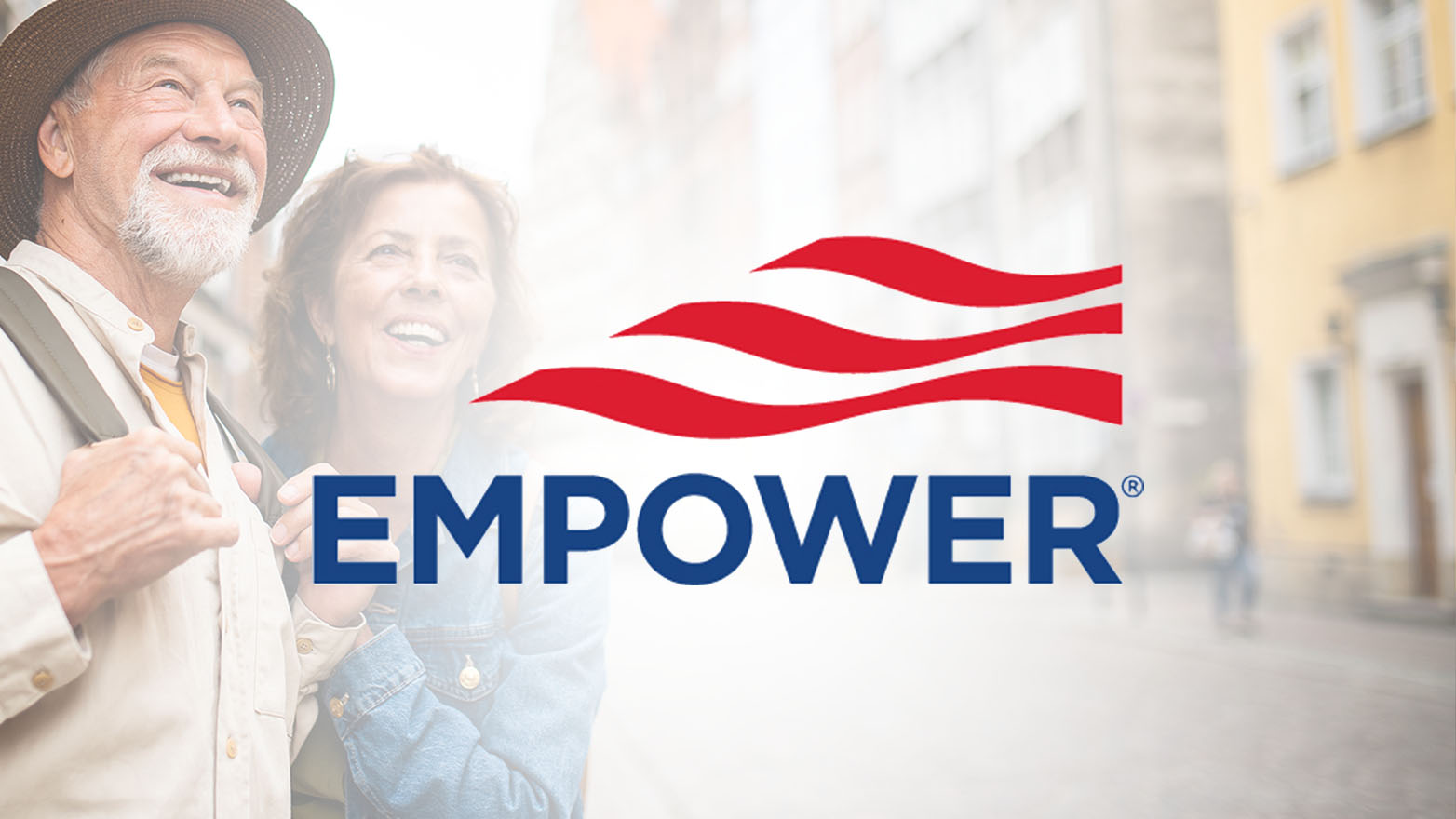 A smiling older couple looks up together, with the Empower logo prominently displayed in front of a blurred cityscape background.