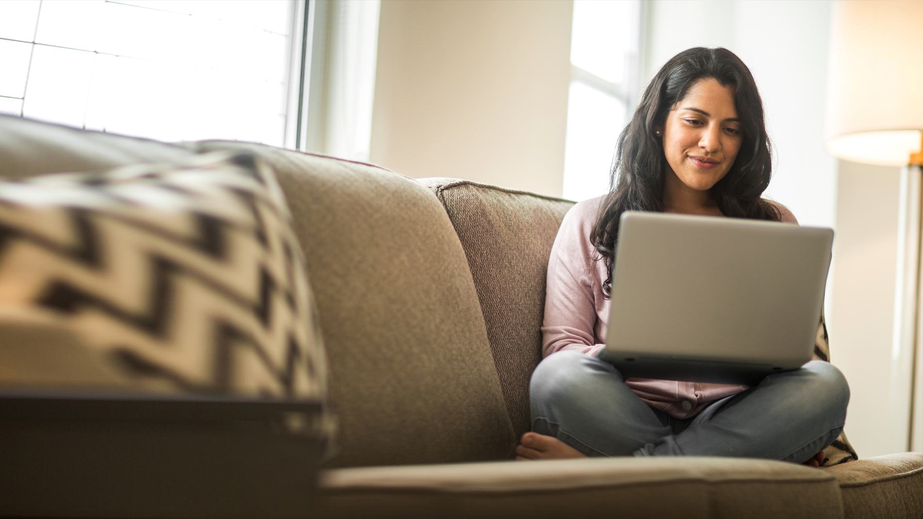 woman on couch with laptop