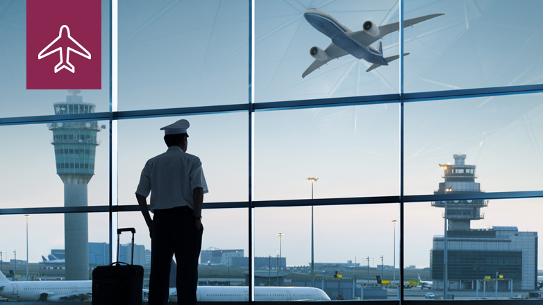 pilot looking out window at airport