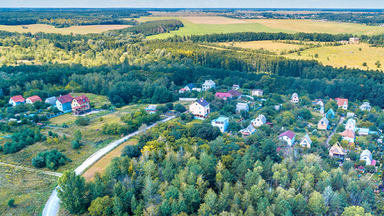 aerial view of small town on countryside with trees