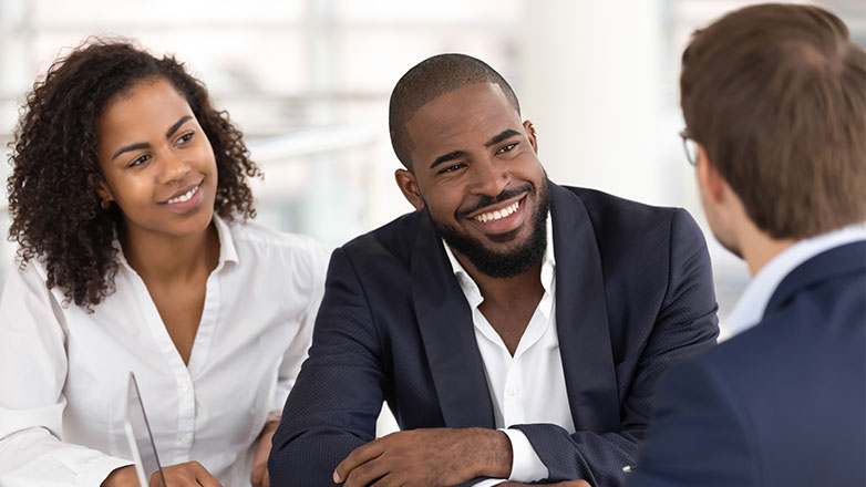 Couple meeting with a loan officer to get their loan pre-approved.