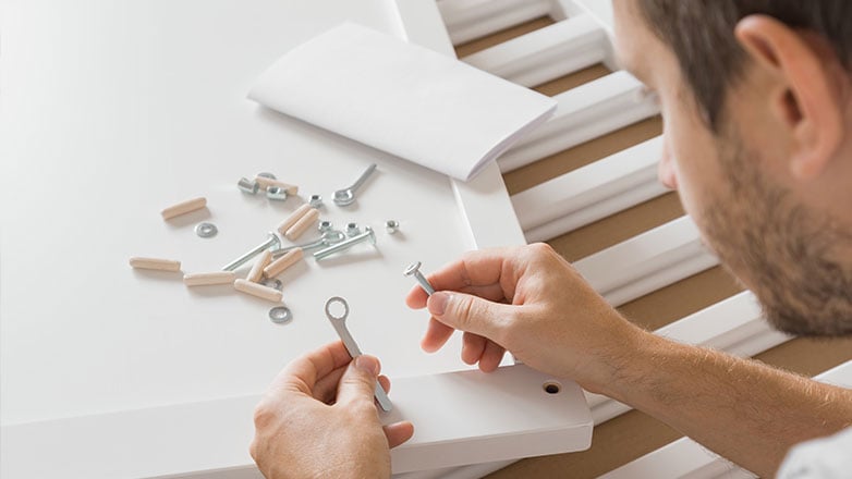 New dad putting the baby crib together.