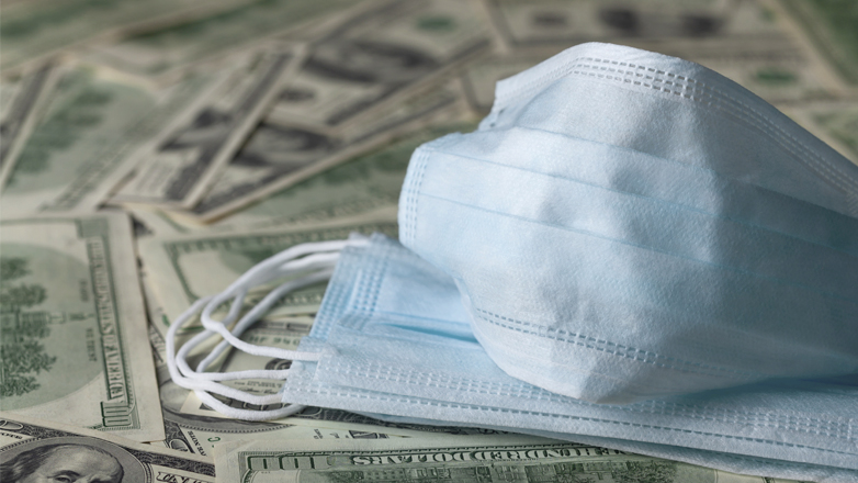 medical masks sitting on us dollars