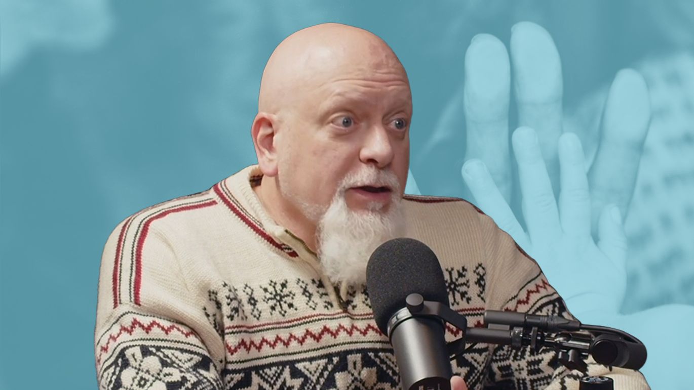 Person speaking into a microphone with a blue-toned image of hands in the background.
