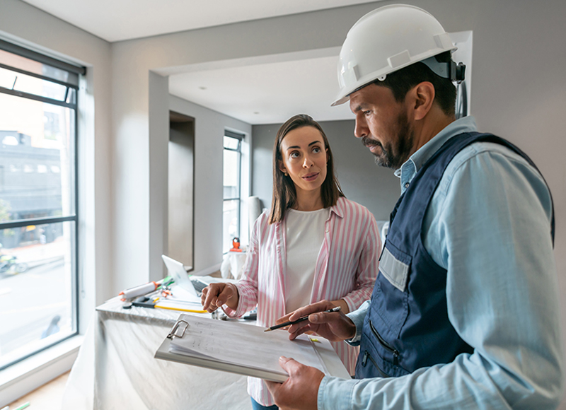 Homeowner talks to contractor about her plans for her house construction.