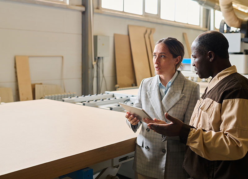 Manager tours the warehouse with the facilities supervisor.