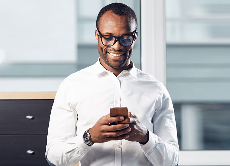 Man uses his smart phone for mobile banking.