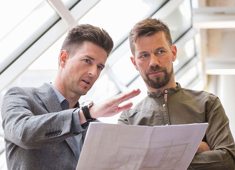 Two business owners reviewing their building plans.