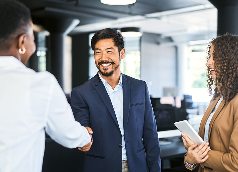 Business colleagues shake hands after a meeting.