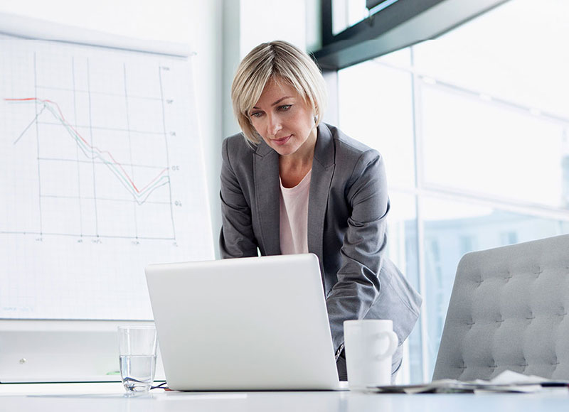 Woman works at a desk in an office in the city.