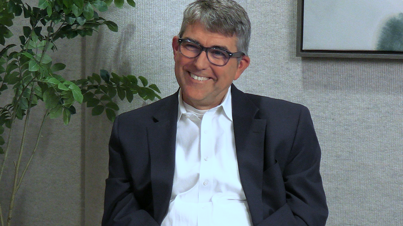 Joe Maier sitting in the studio smiling